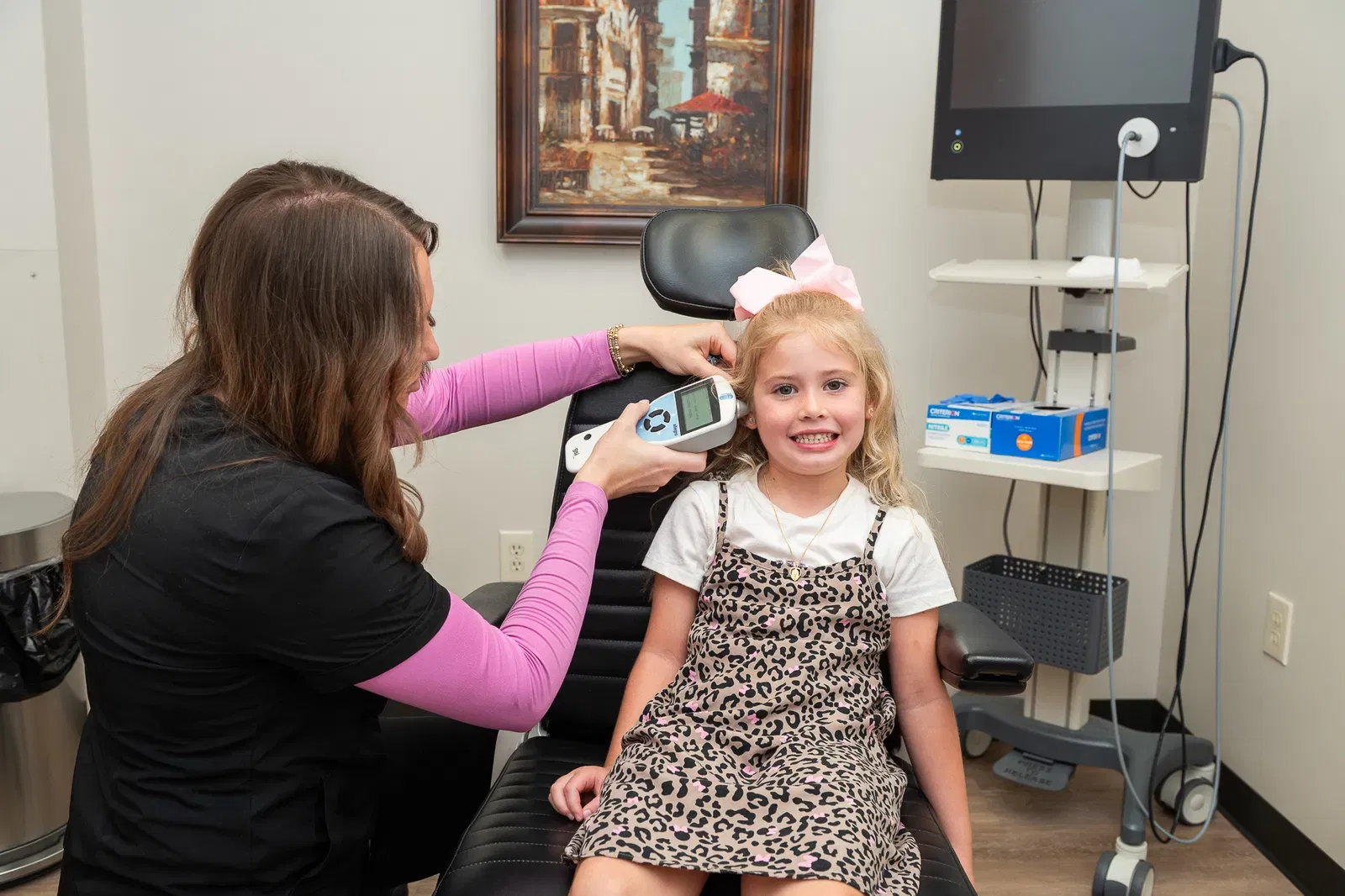 Audiologist performing a hearing evaluation for a child in Birmingham, AL