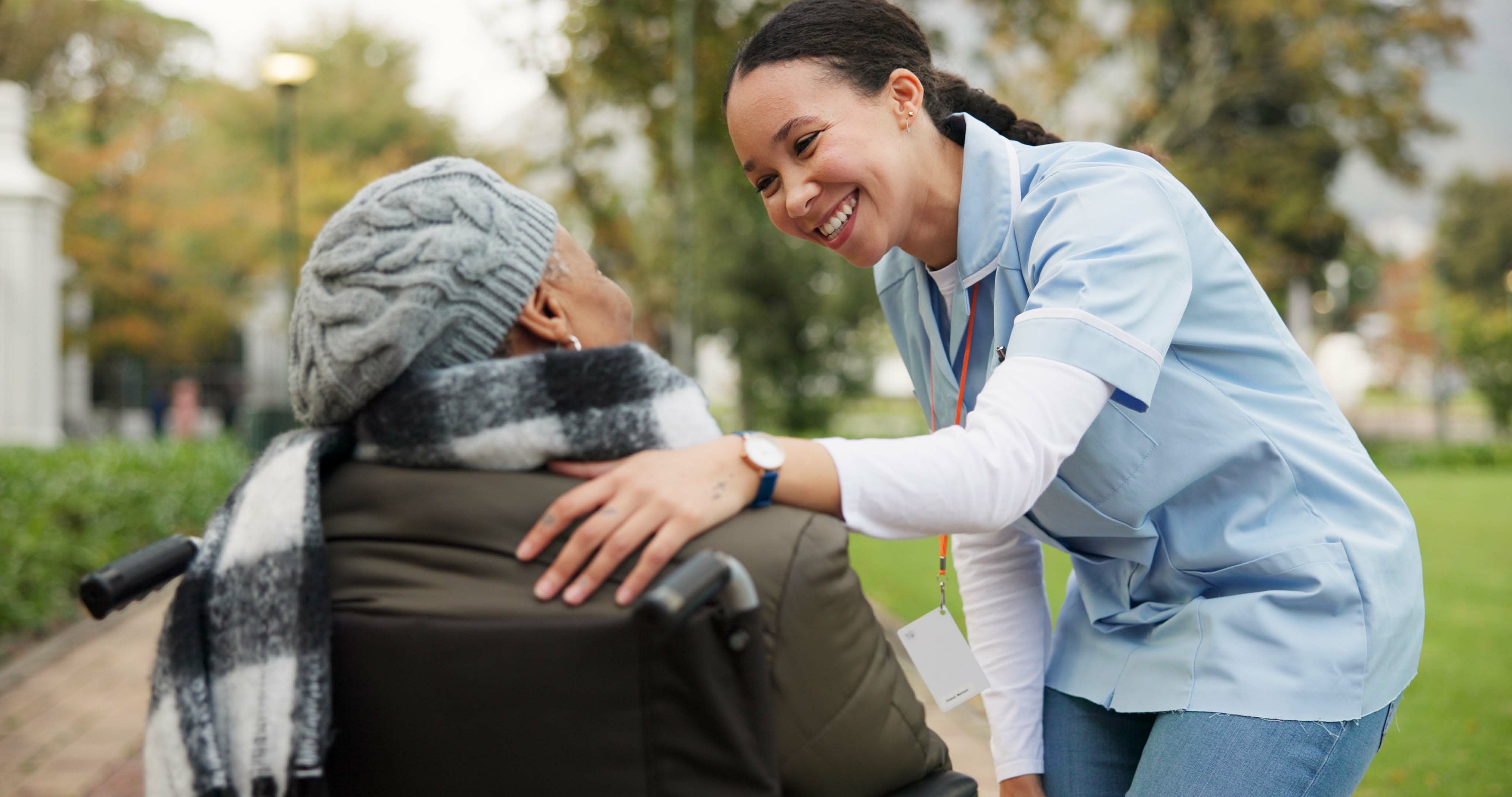 Volunteer smiling at elderly woman