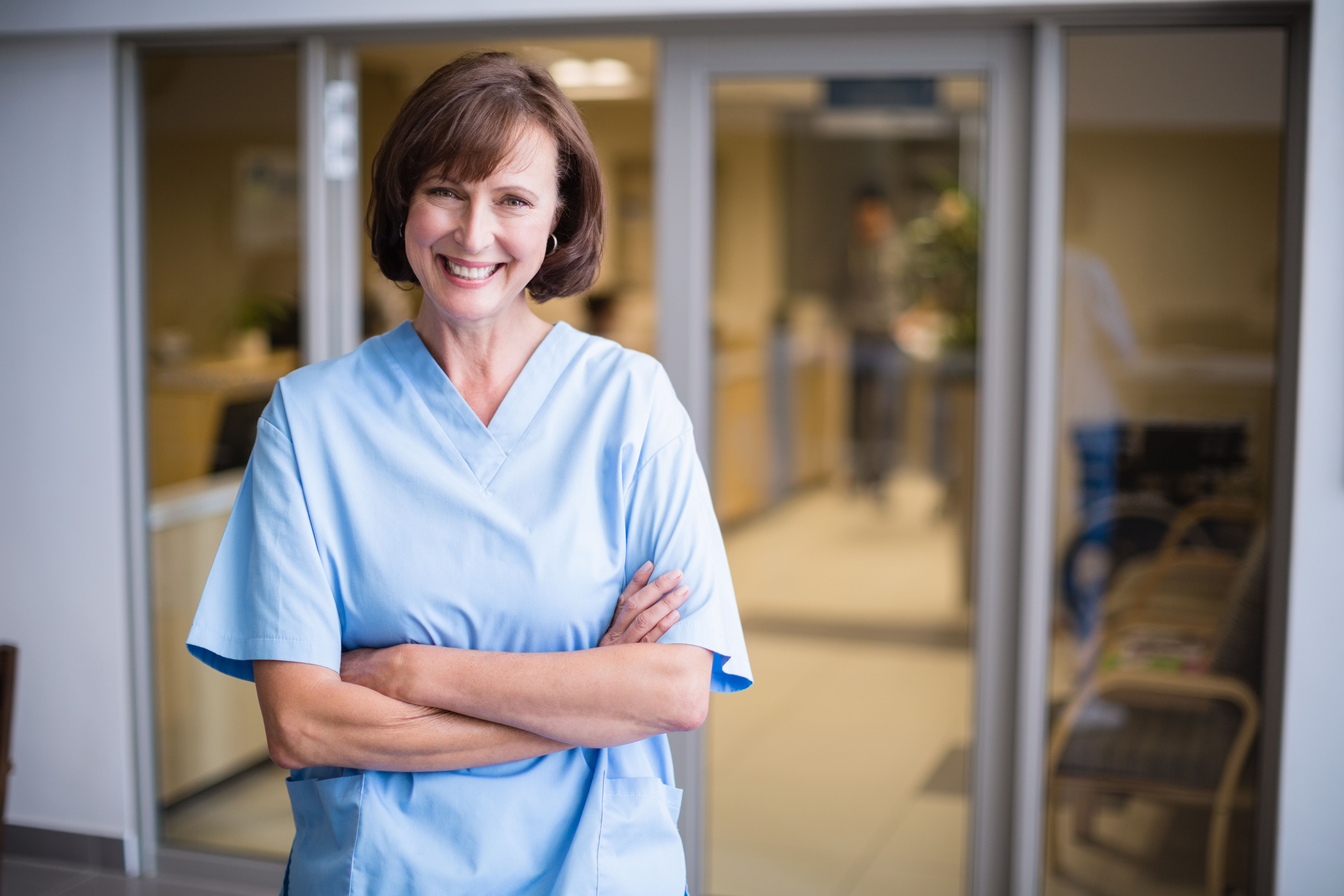 Female doctor smiling with her arms crossed