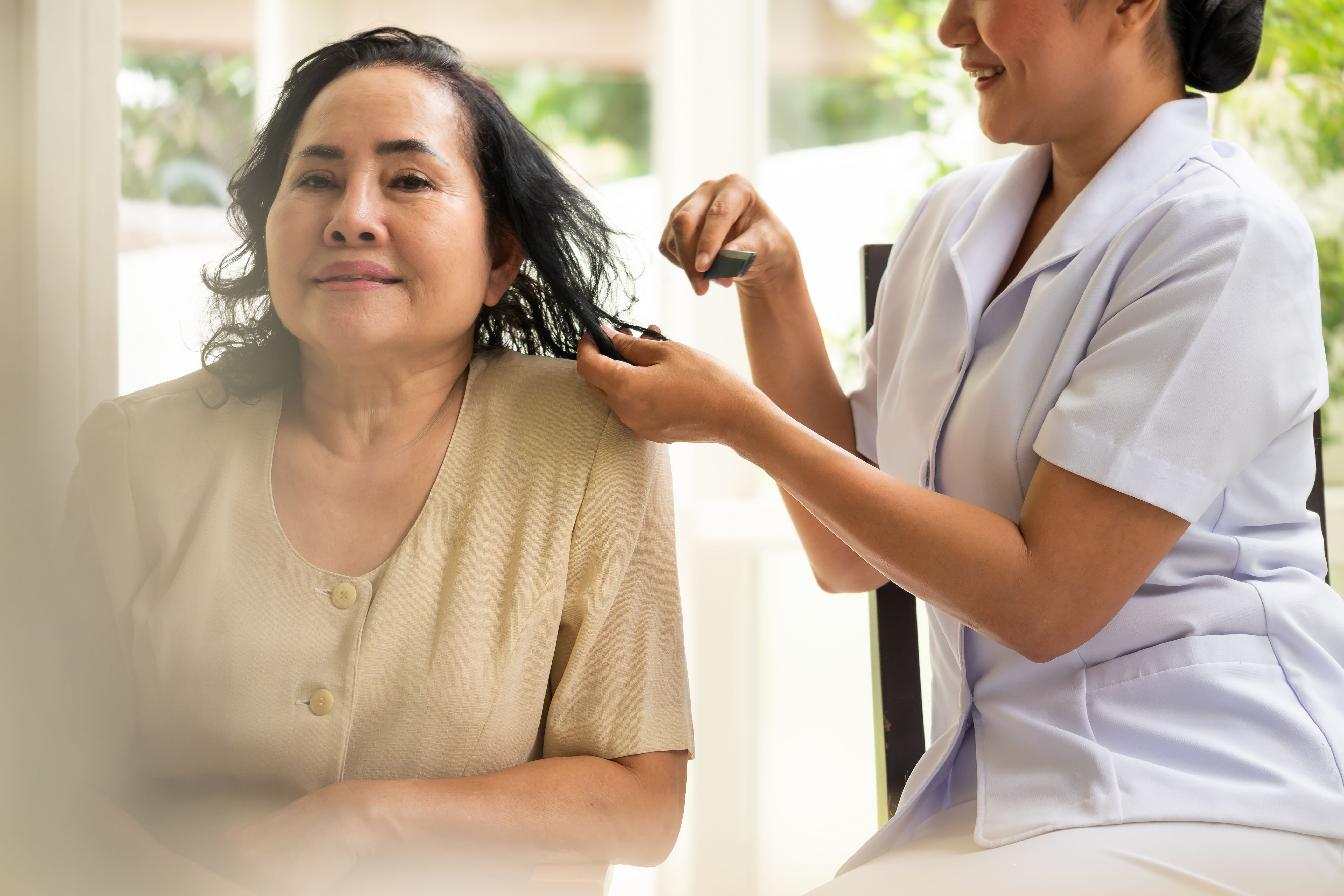 caregiver combing hair of