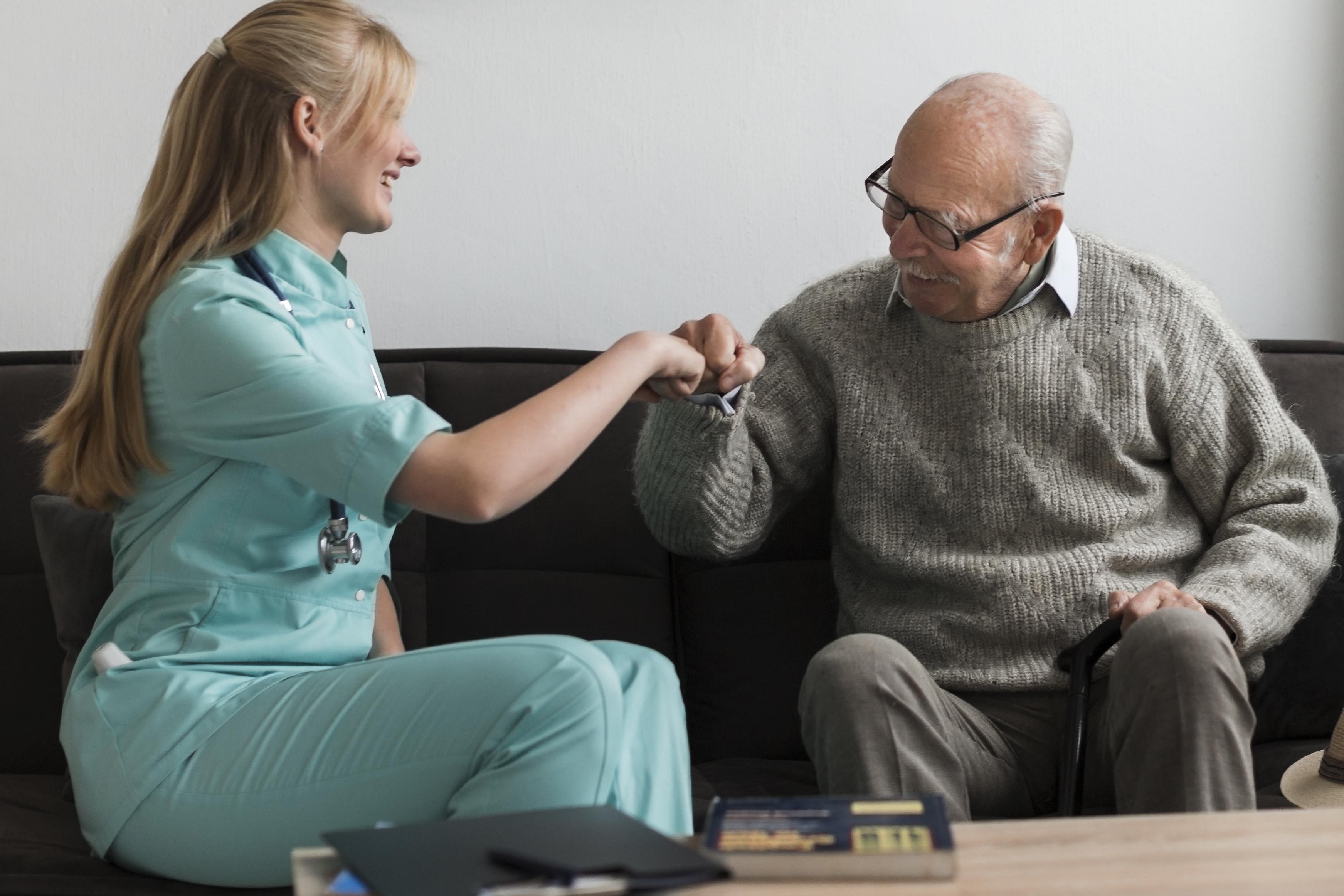 Male Nurse Speaking to Elderly man