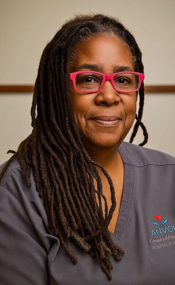 nurse with pink glasses smiling for photo