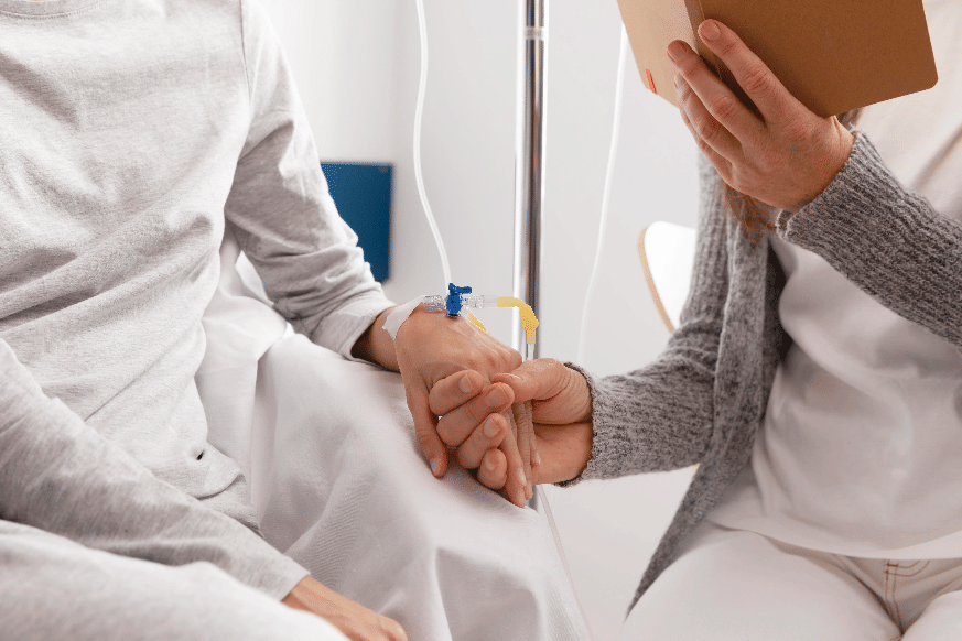 cancer patient hlding nurses hand