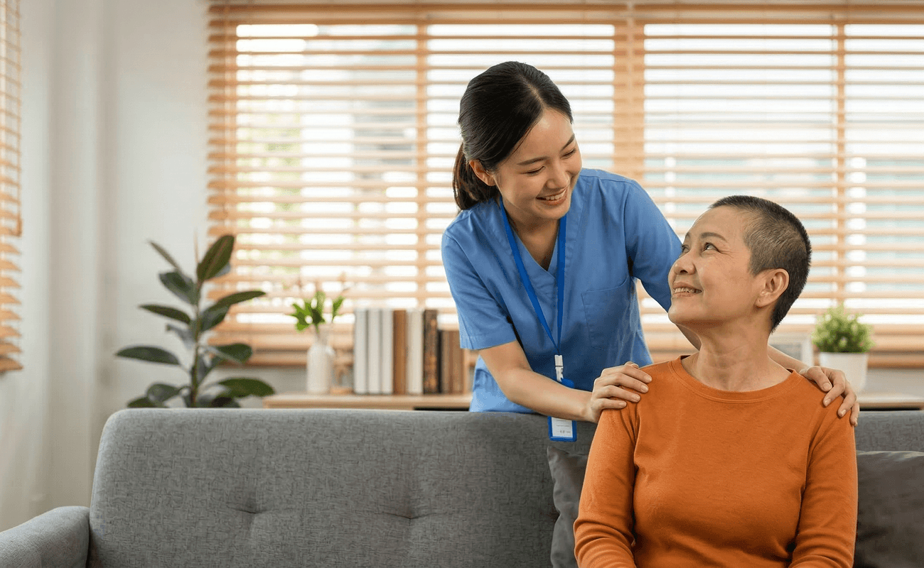 Hospice nurse smiling down at hospice patient