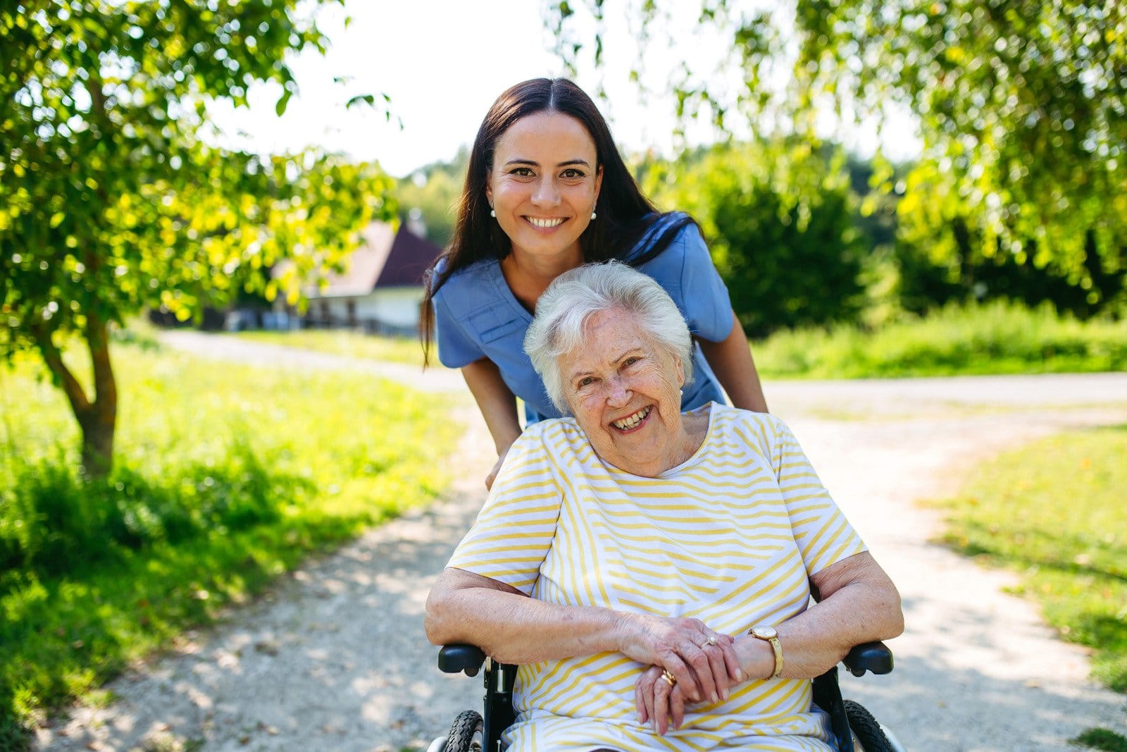 home nurse taking care of an elderly woman in wheelchair
