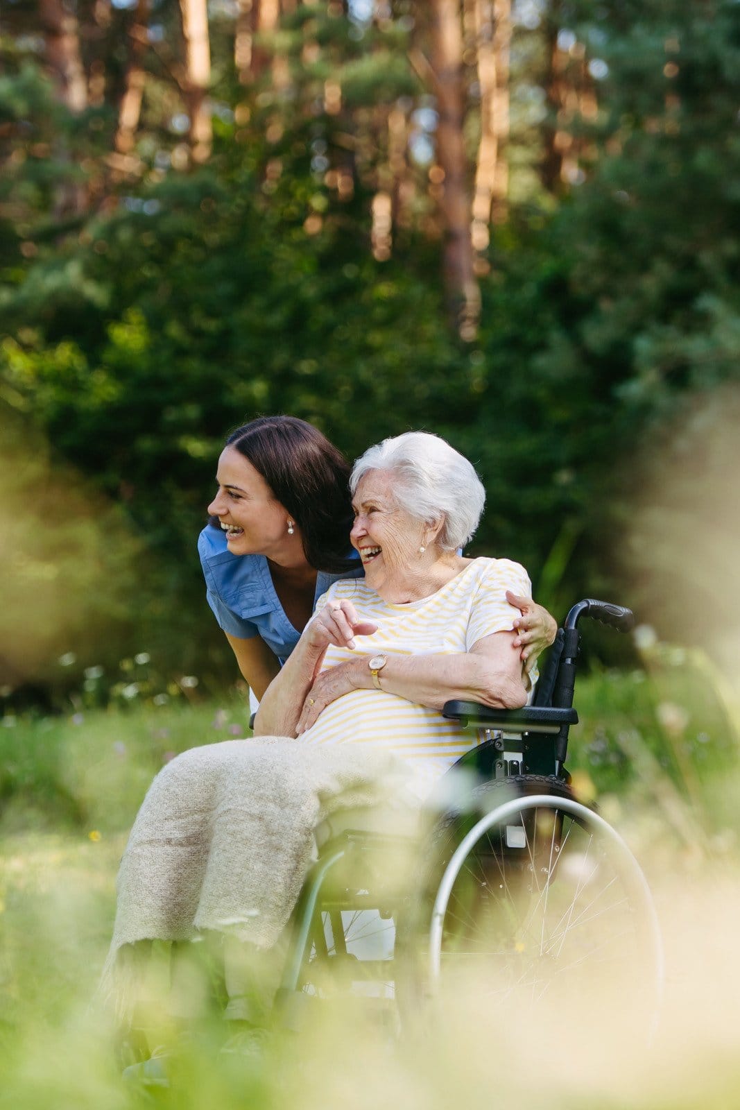 home nurse taking care of an elderly woman in a wheelchair