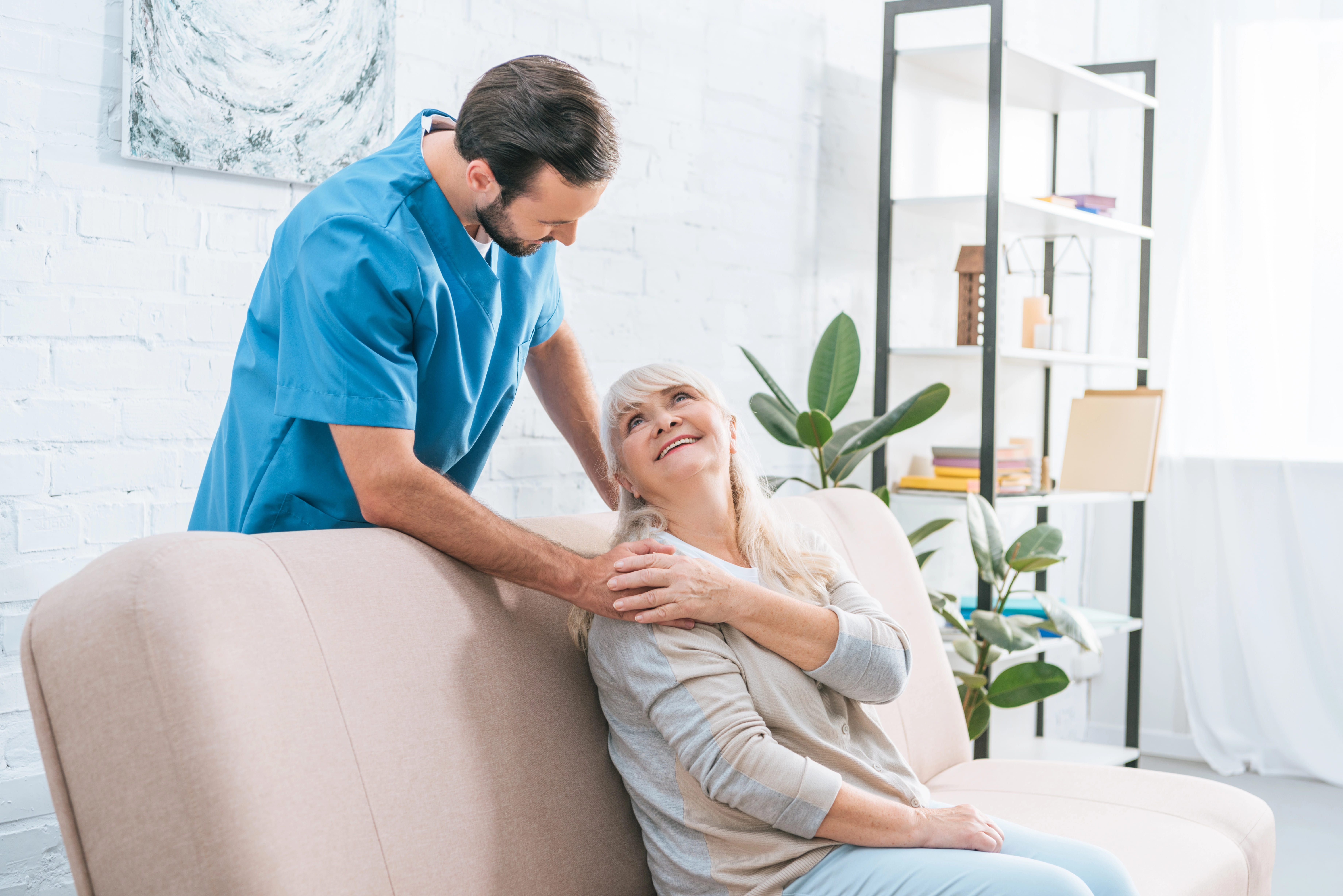 Older woman gazing back at hospice care worker with gratitude