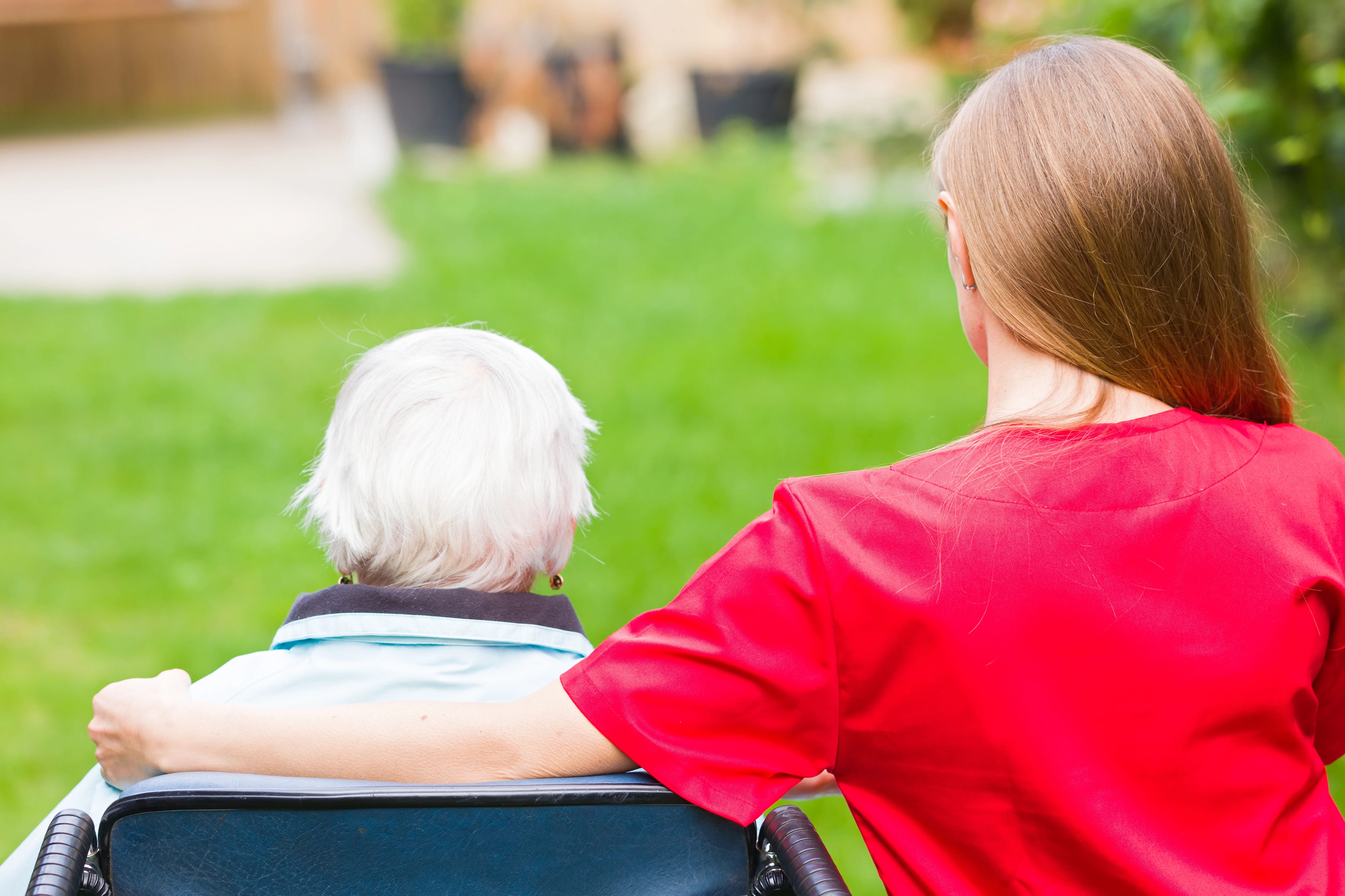 Young woman sitting next to her grandmother in a park