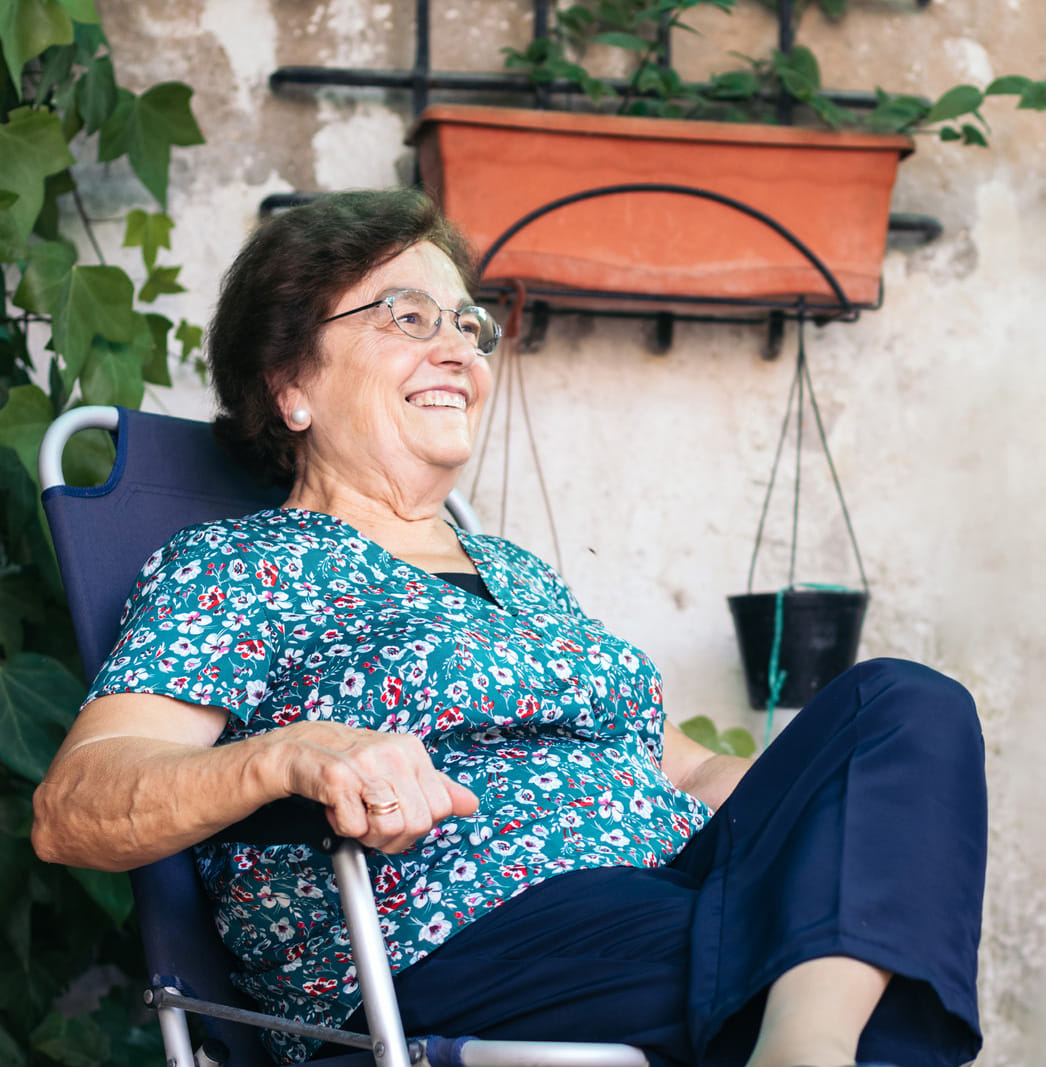 elderly woman in a patio chair