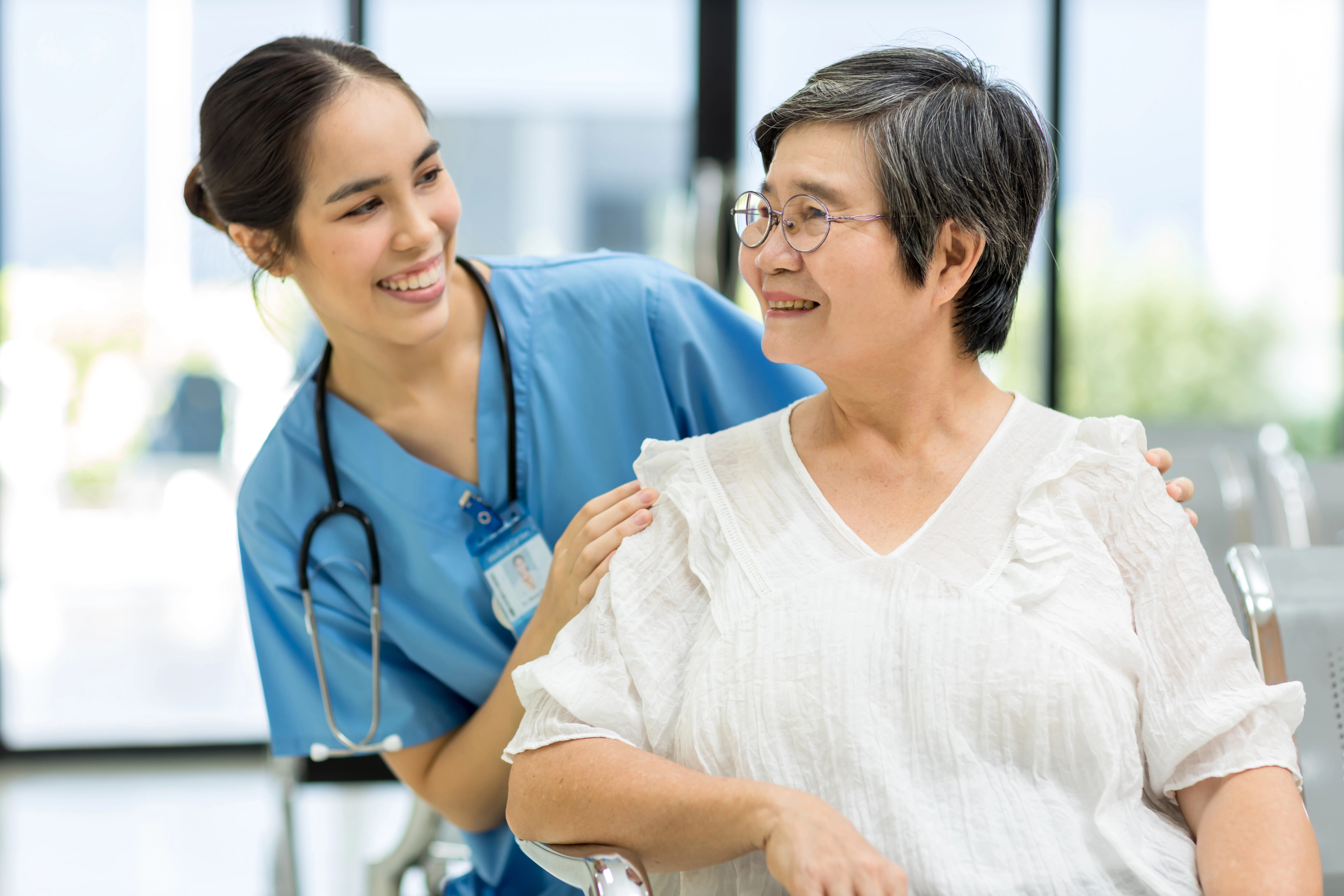 Hospice Care nurse checking in on patient ina wheelchair