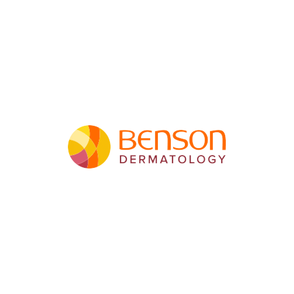 Three medical team members at Benson Dermatology smiling together.
