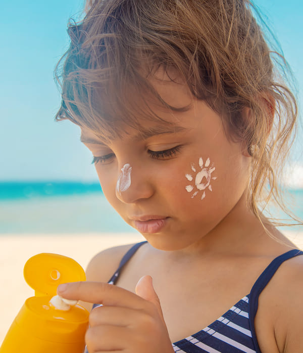 young child with sunscreen on nose and cheek