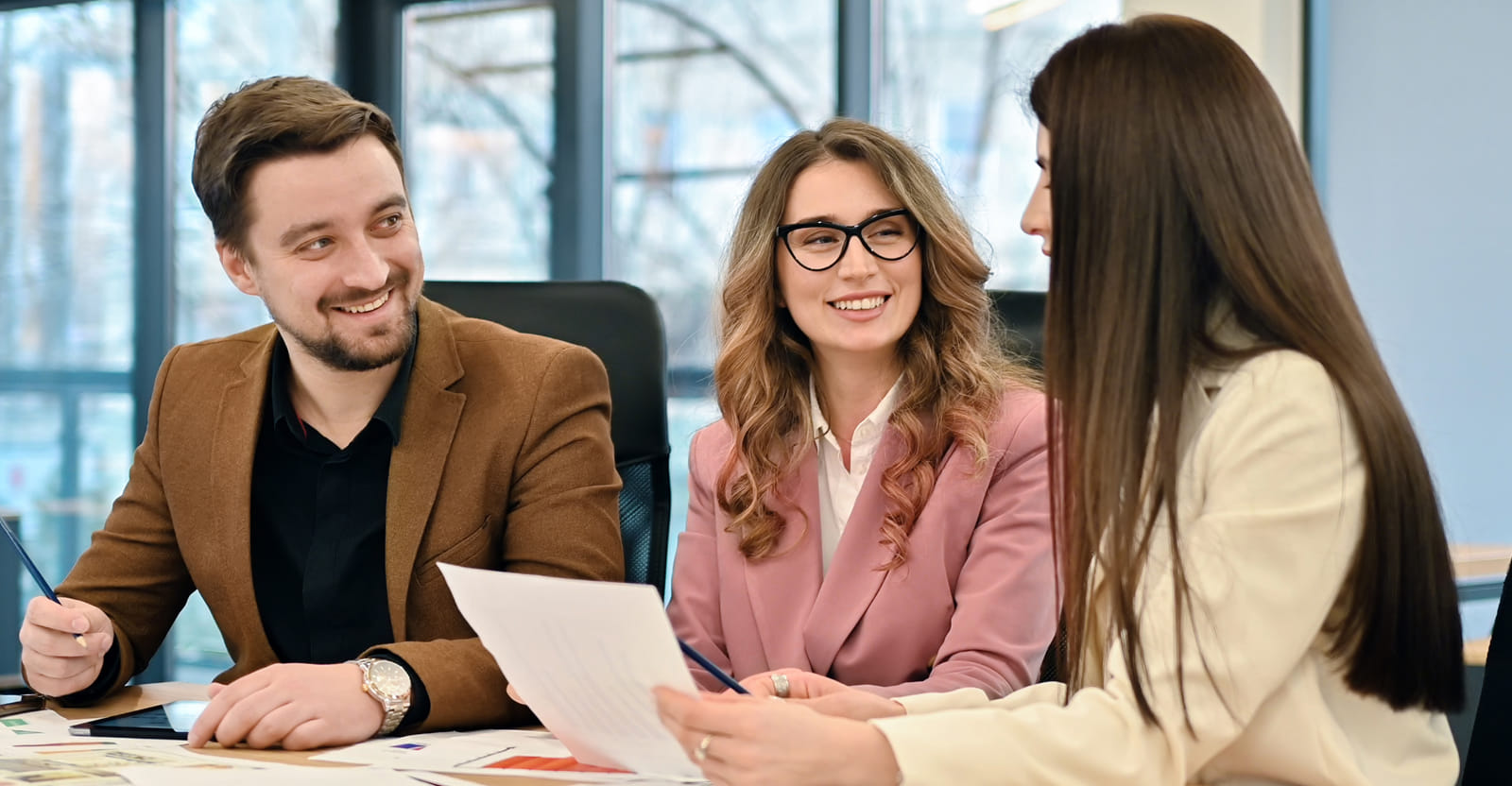 Crescent Title team reviewing real estate documents with clients Crescent Title team reviewing real estate documents with clients
