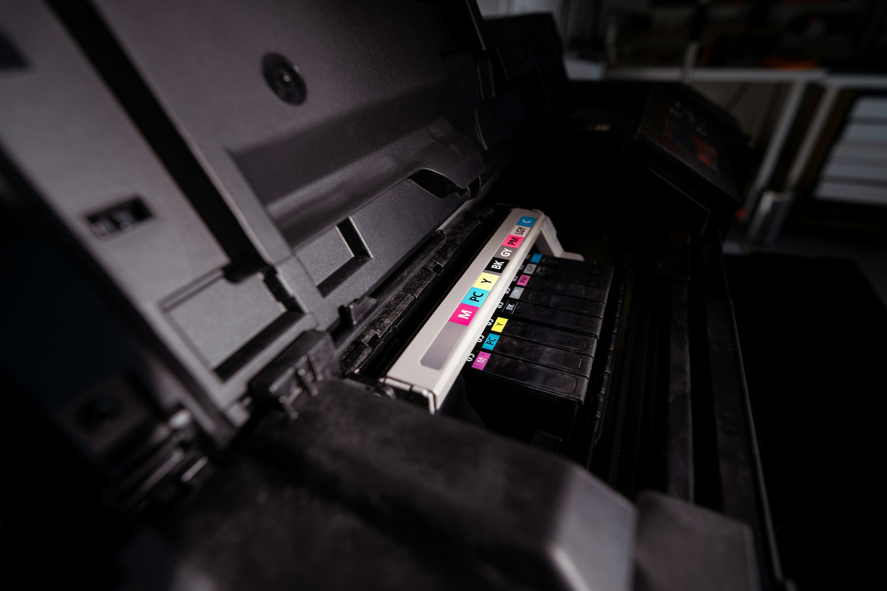 Office employee loading paper into a commercial multifunction printer Office employee loading paper into a commercial multifunction printer