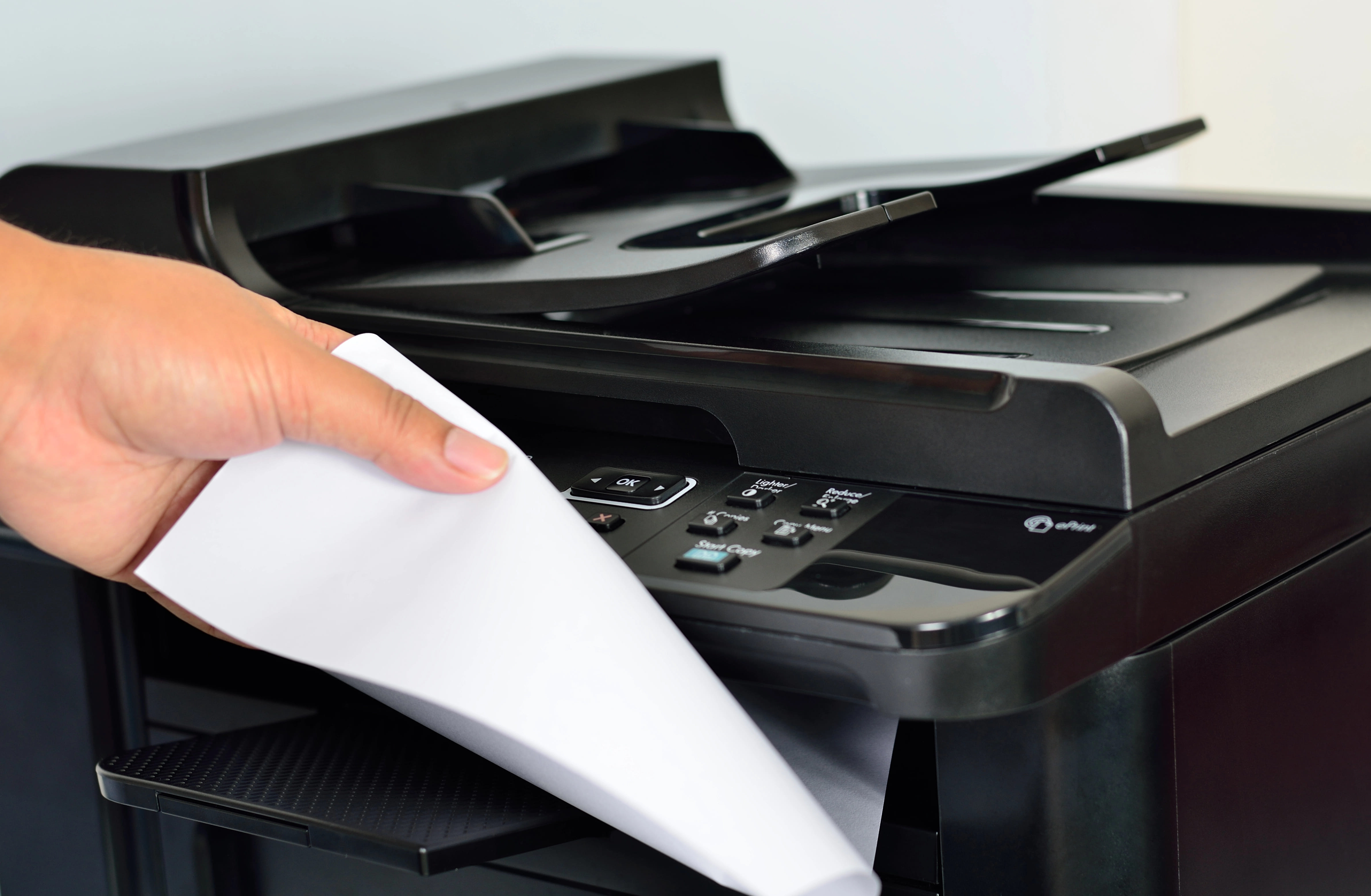 Professional using multifunction printer to scan and copy documents