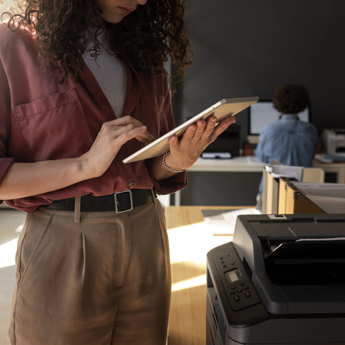 Business printer producing documents in a professional office environment