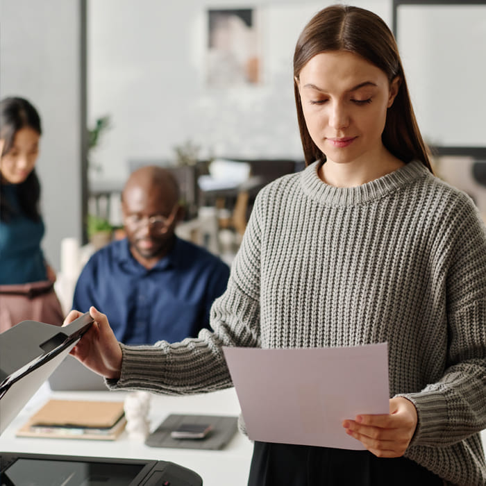 Professional using multifunction printer to scan and copy documents