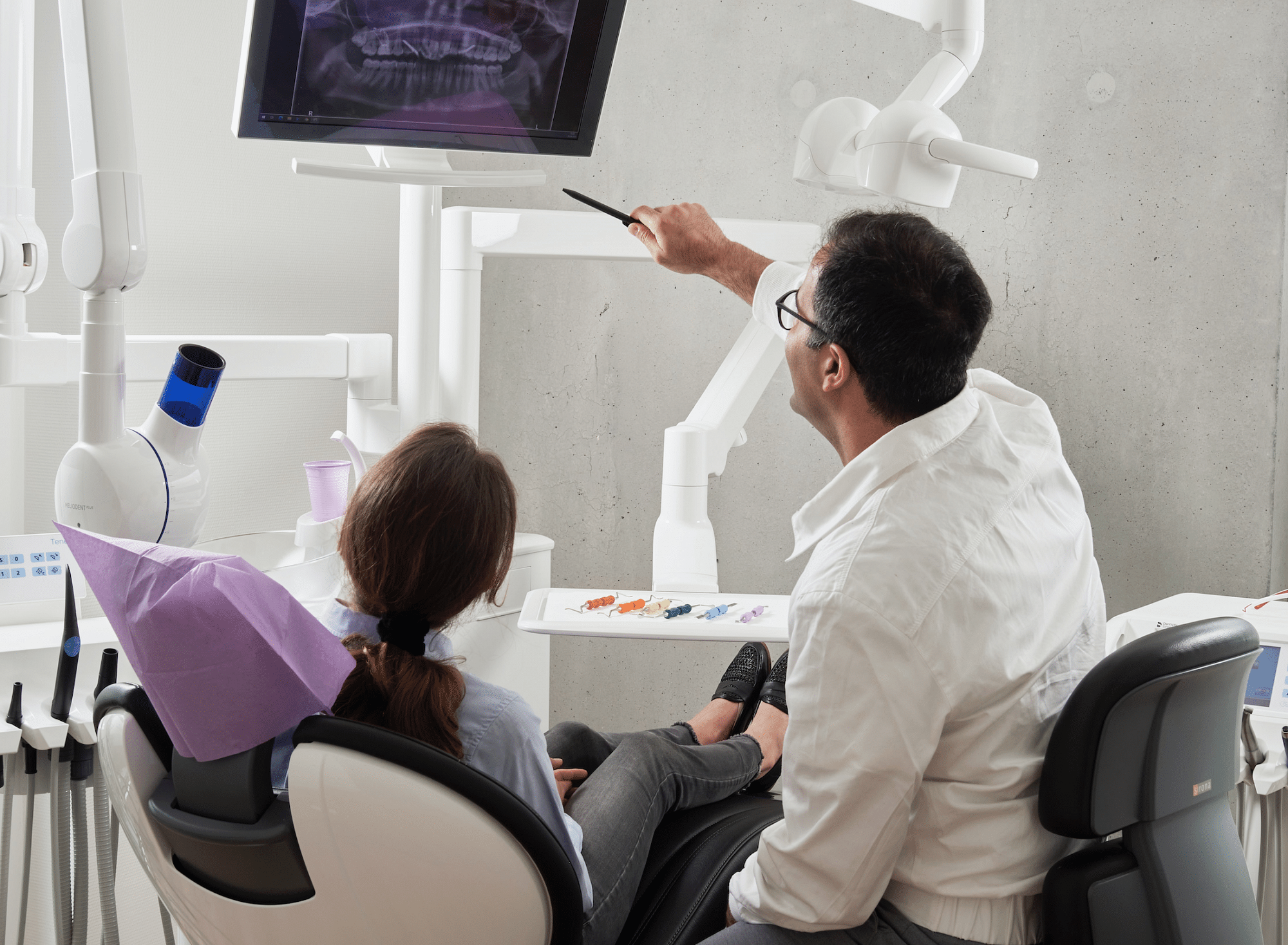 dentist looking over dental x-ray