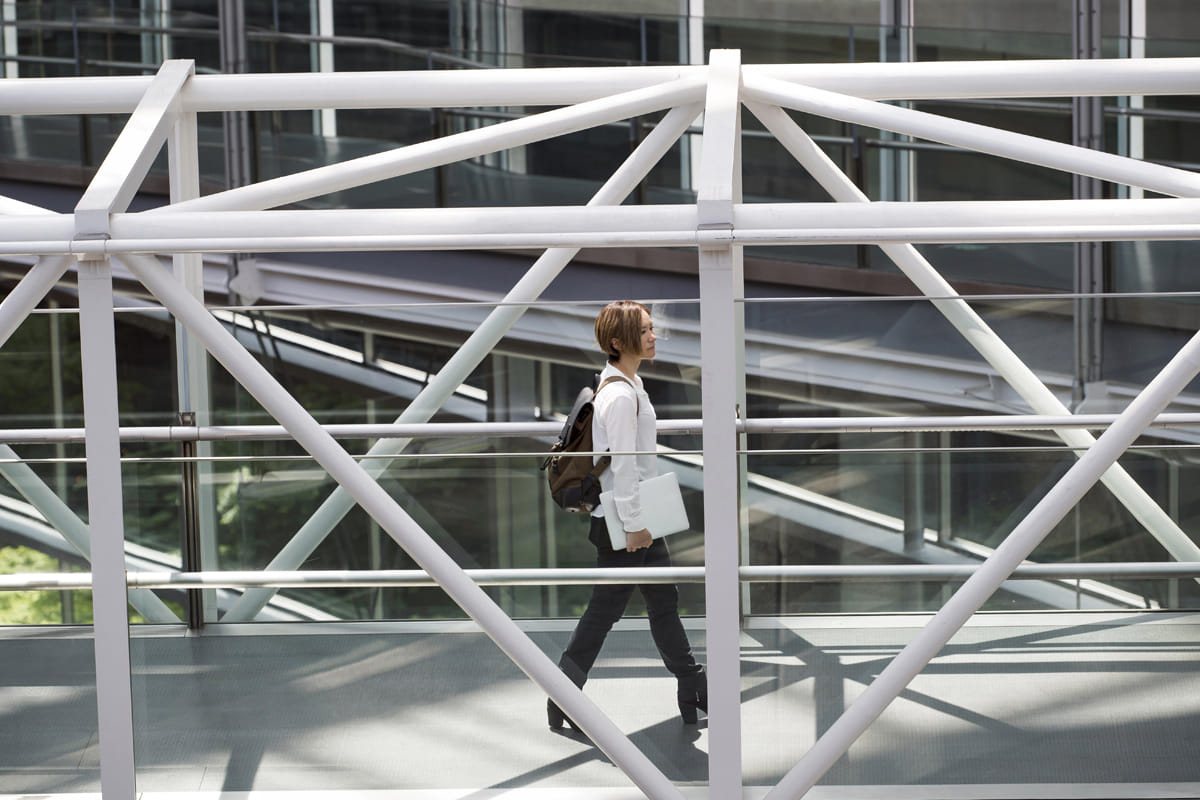 woman walking on bridge in building