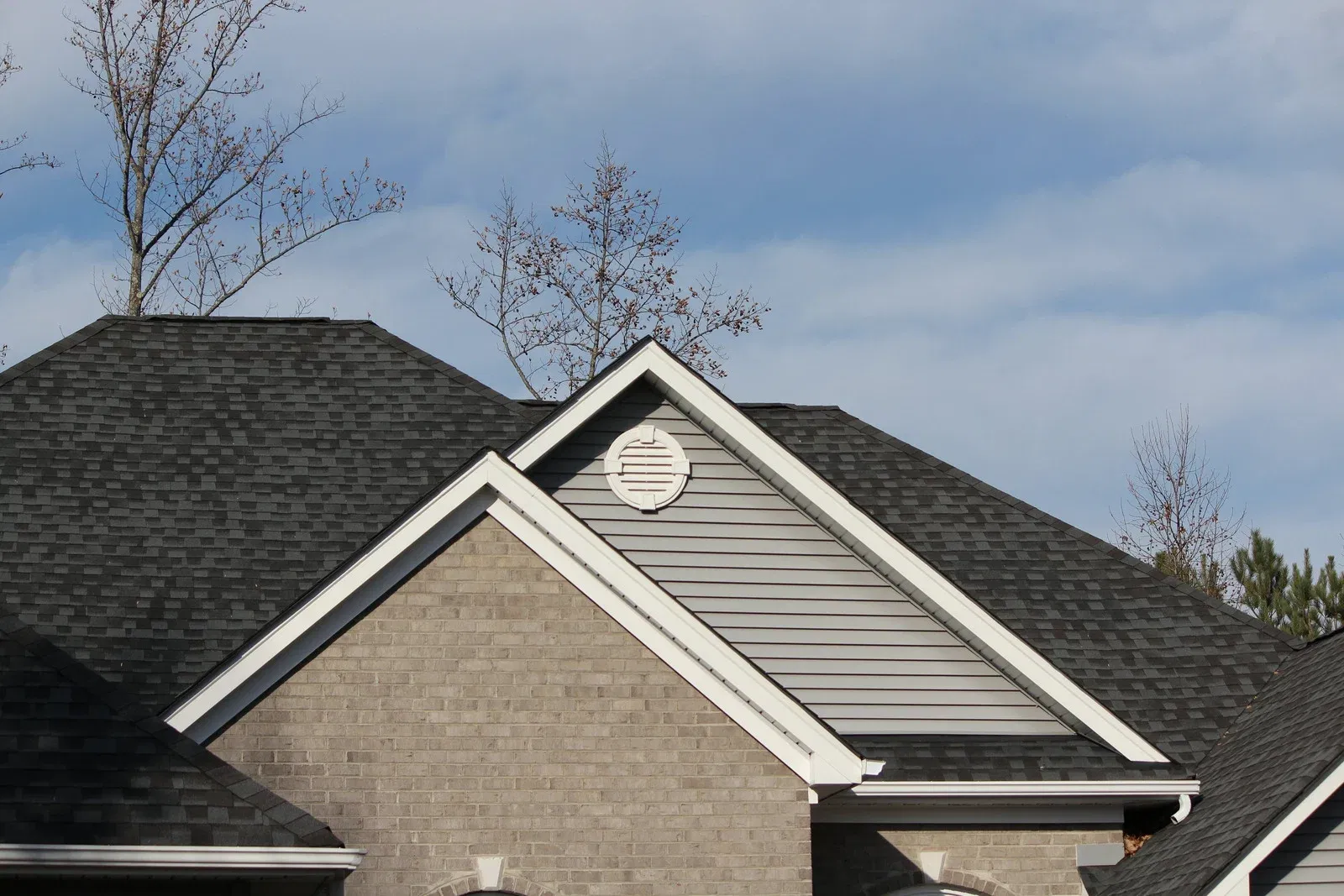 Residential home with new asphalt shingle roof and gable vents in Keller TX Residential home with new asphalt shingle roof and gable vents in Keller TX