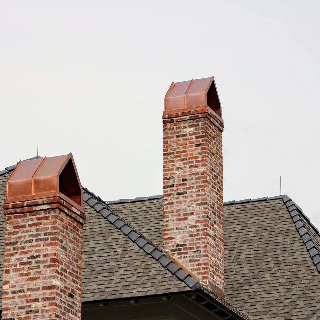 Brick chimney and brown shingles on roof